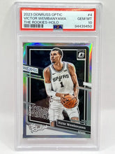 Load image into Gallery viewer, 2023 Panini Optic Victor Wembanyama Holo The Rookies PSA 10 Spurs
